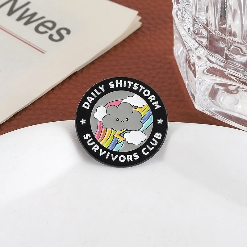 the SHITSTORM SURVIVOR - Daily Shitstorm Survivors Club Enamel Pin, Cartoon Dark Clouds Rainbow Brooch Lapel, Badge Jewelry Gift for Friends