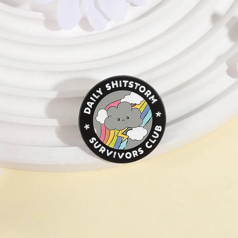 the SHITSTORM SURVIVOR - Daily Shitstorm Survivors Club Enamel Pin, Cartoon Dark Clouds Rainbow Brooch Lapel, Badge Jewelry Gift for Friends