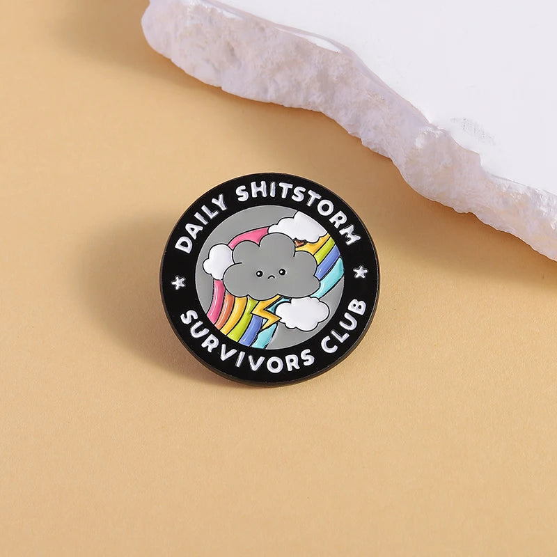 the SHITSTORM SURVIVOR - Daily Shitstorm Survivors Club Enamel Pin, Cartoon Dark Clouds Rainbow Brooch Lapel, Badge Jewelry Gift for Friends