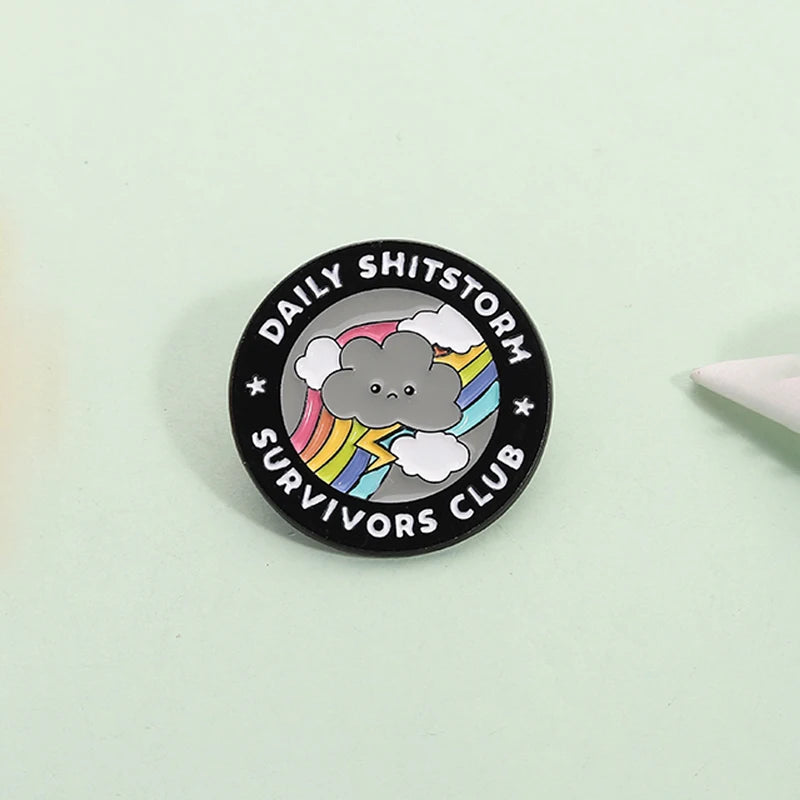 the SHITSTORM SURVIVOR - Daily Shitstorm Survivors Club Enamel Pin, Cartoon Dark Clouds Rainbow Brooch Lapel, Badge Jewelry Gift for Friends