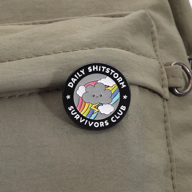 the SHITSTORM SURVIVOR - Daily Shitstorm Survivors Club Enamel Pin, Cartoon Dark Clouds Rainbow Brooch Lapel, Badge Jewelry Gift for Friends